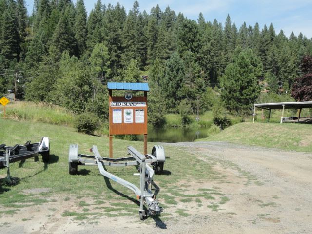 Boat trailer in front of park sign