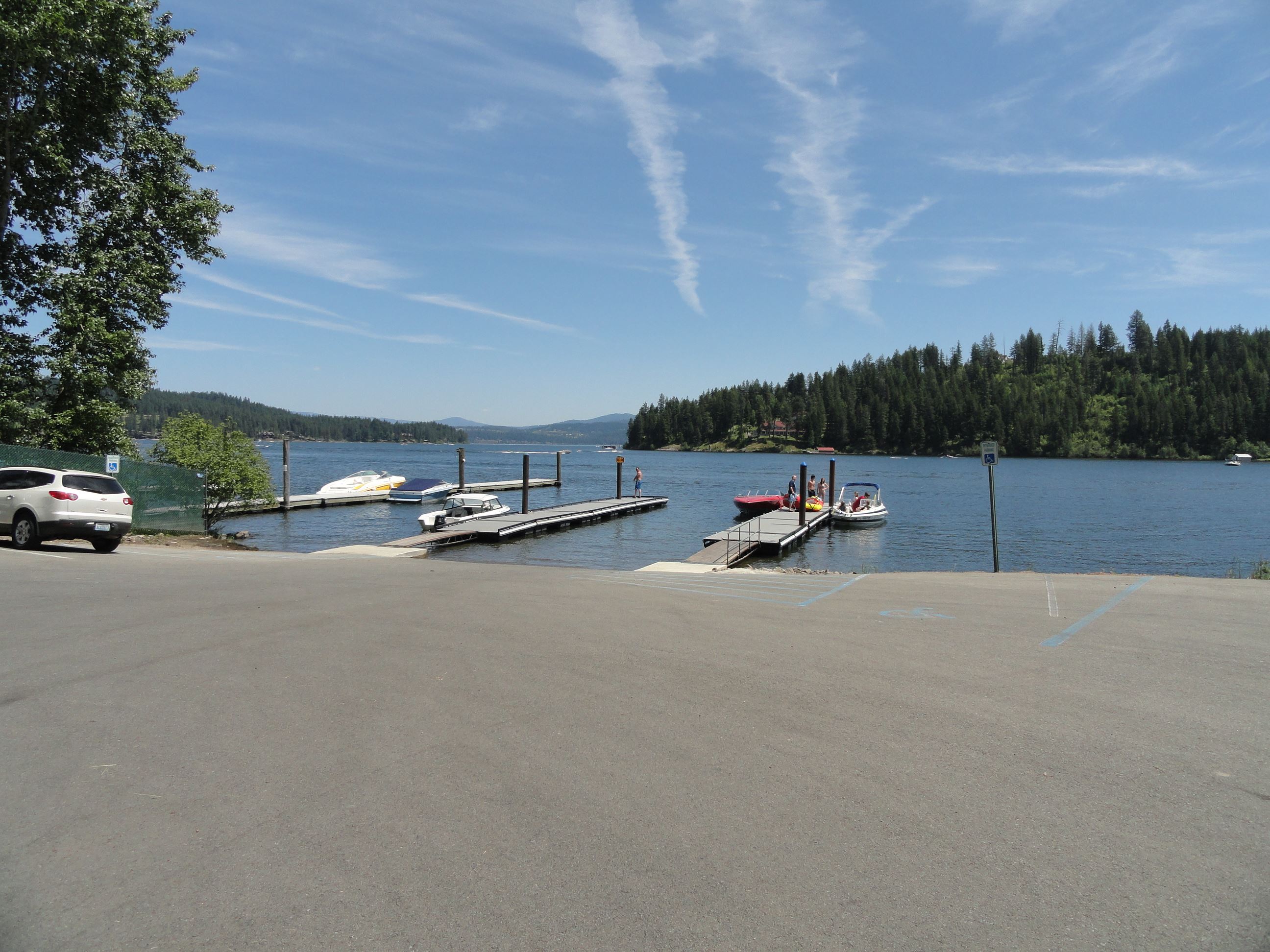 Paved parking lot leading to docks on lake