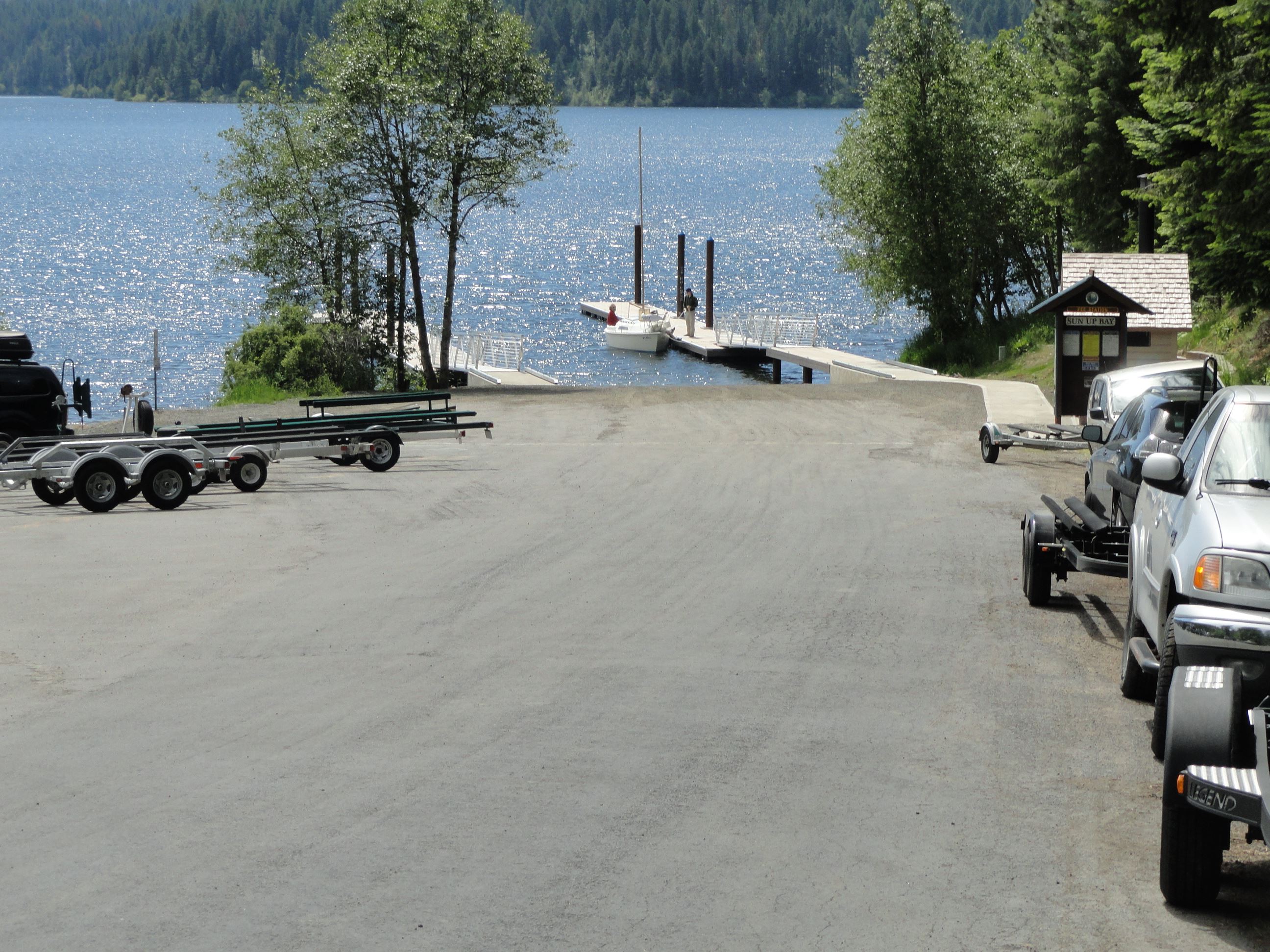 Road leading to lake with dock and launch